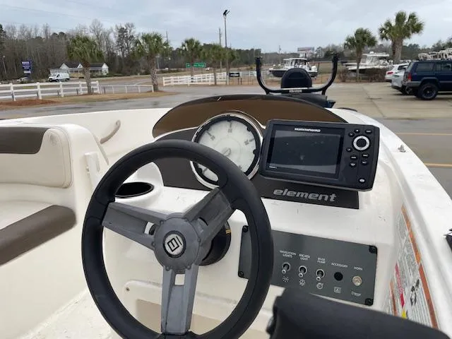 Slide: The Image of 2020 Bayliner Element E16 boat dashboard with steering wheel and navigation system. - 6