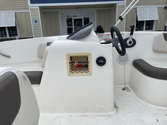 Slide: The Image of 2020 Bayliner Element E16 boat interior with steering wheel and seating. - 8