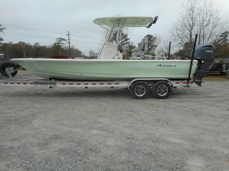 Slide: The Image of 2024 Avenger 26 Avenger boat on a trailer with Yamaha outboard motor. - 1
