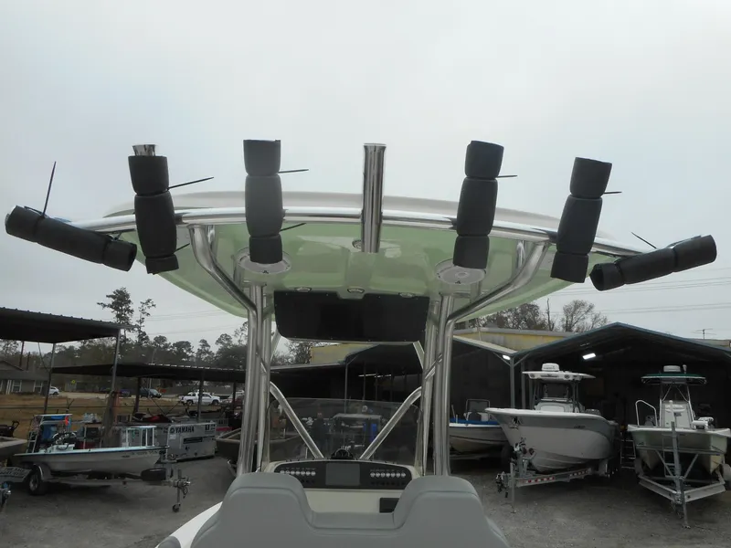 Slide: The Image of 2024 Avenger 26 Avenger boat with rod holders and canopy in a marina. - 15