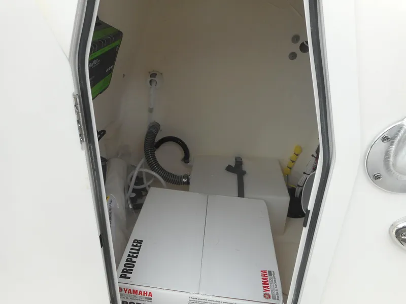 Slide: The Image of 2024 Avenger 26 Avenger boat storage compartment with Yamaha propeller box. - 16