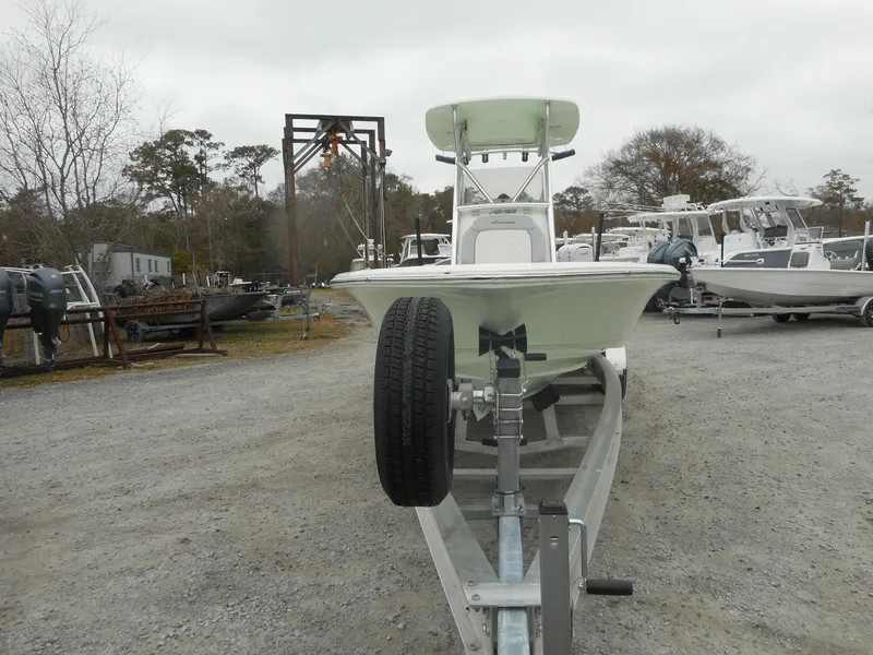 Slide: The Image of 2024 Avenger 26 Avenger boat on trailer in a boatyard. - 2