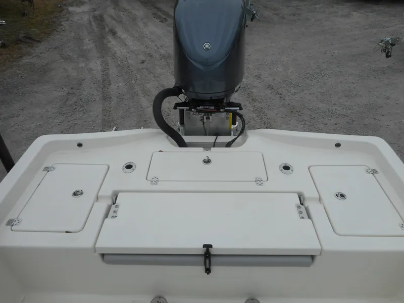 Slide: The Image of 2024 Avenger 26 Avenger boat stern with outboard motor and storage compartments. - 7