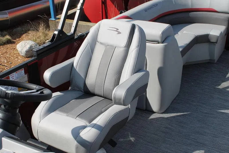 Slide: The Image of 2024 Bennington 23 SXSR boat interior with gray captain's chair and seating area. - 5