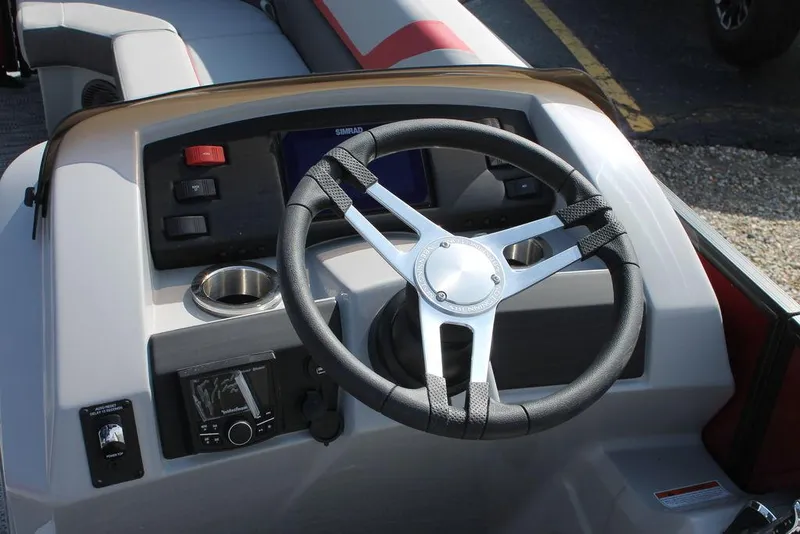 Slide: The Image of 2024 Bennington 23 SXSR boat steering console with modern controls and cup holder. - 6
