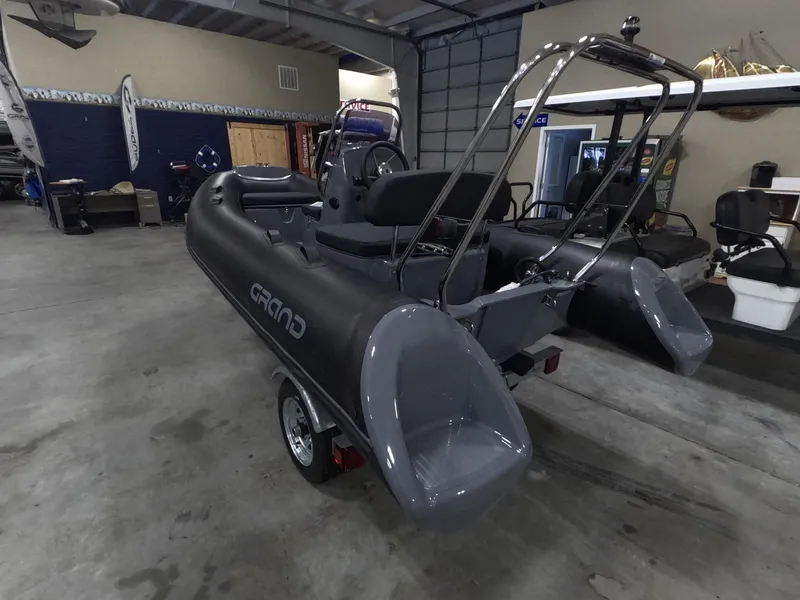 Slide: The Image of 2024 Grand Inflatables S370NL boat in showroom, rear view. - 3