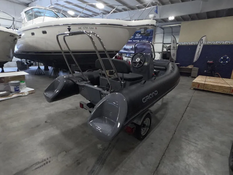 Slide: The Image of 2024 Grand Inflatables S370NL boat in showroom, rear view. - 4