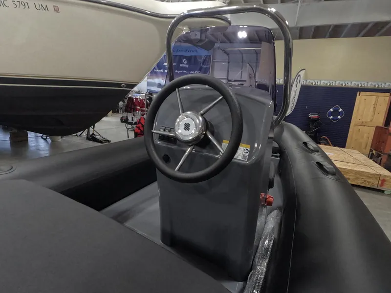 Slide: The Image of 2024 Grand Inflatables S370NL boat interior with steering wheel and control console. - 6