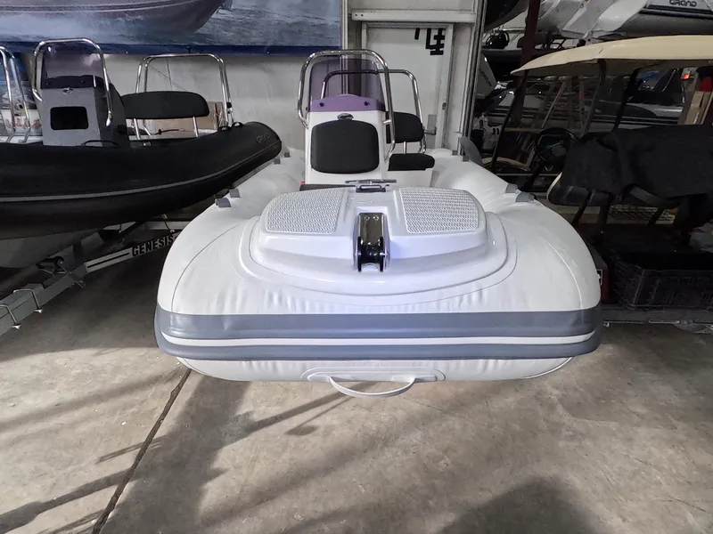 Slide: The Image of 2024 Grand Inflatables S370NL boat in storage, front view. - 2