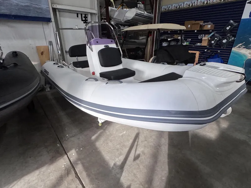 Slide: The Image of 2024 Grand Inflatables S370NL boat in a showroom. - 3