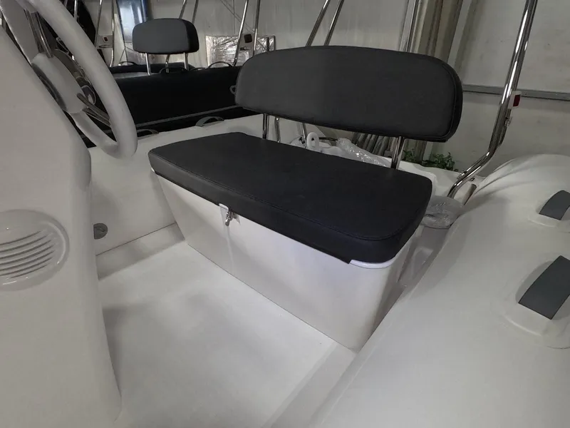 Slide: The Image of 2024 Grand Inflatables S370NL boat interior with black cushioned seating. - 8