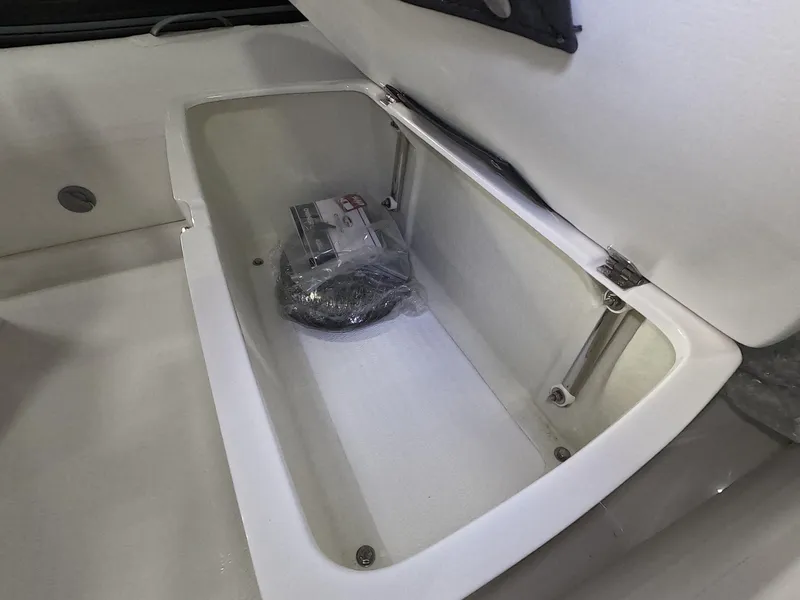 Slide: The Image of 2024 Grand Inflatables S370NL storage compartment with lid open. - 9