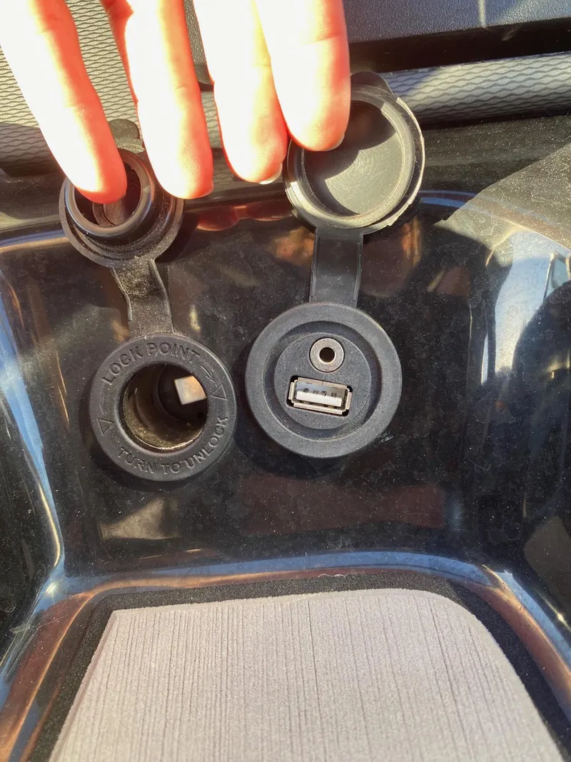 Slide: The Image of USB and 12V power outlets on a 2018 Yamaha Boats AR240 HO. - 12