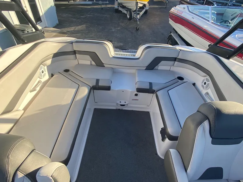Slide: The Image of 2018 Yamaha Boats AR240 HO interior seating area with gray and white upholstery. - 15