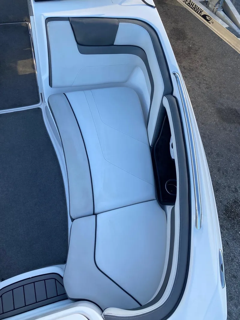 Slide: The Image of 2018 Yamaha Boats AR240 HO interior seating area with white and gray upholstery. - 17