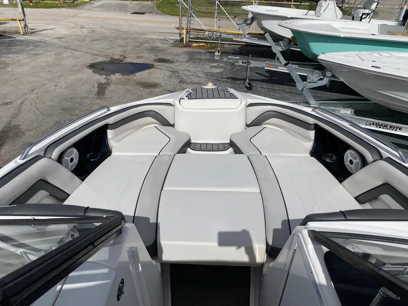 Slide: The Image of 2018 Yamaha Boats AR240 HO bow seating area with gray upholstery. - 19