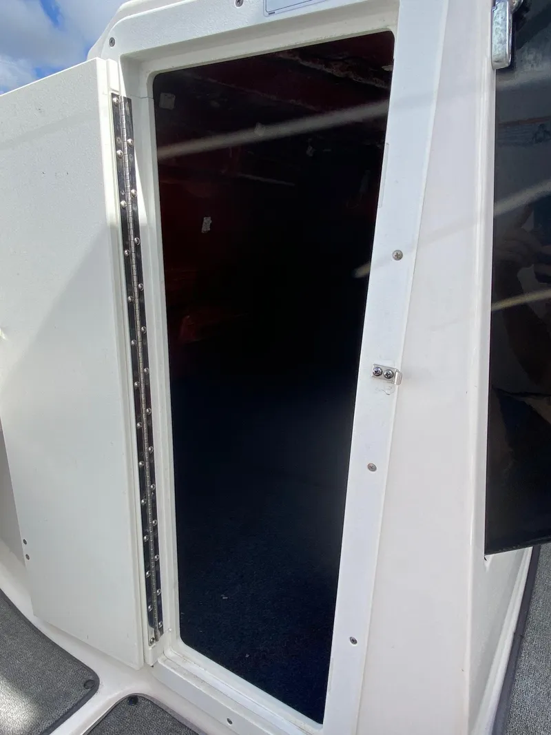 Slide: The Image of 2018 Yamaha Boats AR240 HO cabin entrance with open door. - 23