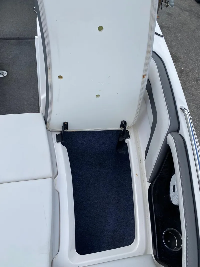 Slide: The Image of 2018 Yamaha Boats AR240 HO storage compartment with open hatch. - 29