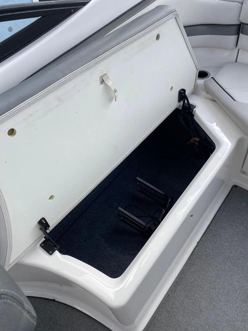 Slide: The Image of 2018 Yamaha Boats AR240 HO storage compartment with open lid. - 31