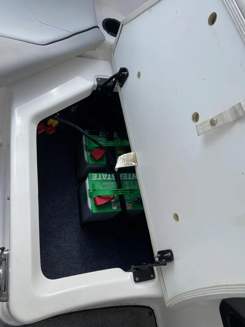 Slide: The Image of 2018 Yamaha Boats AR240 HO battery compartment with dual batteries. - 32