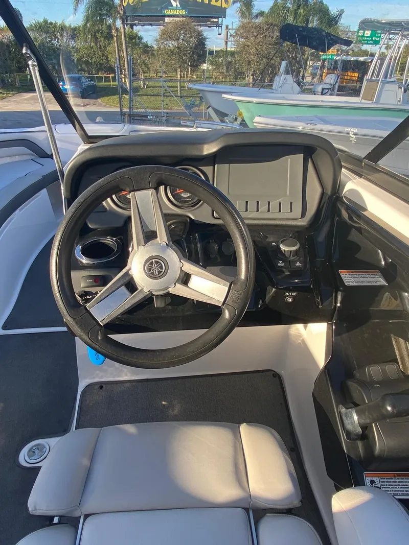 Slide: The Image of 2018 Yamaha Boats AR240 HO cockpit with steering wheel and dashboard controls. - 6