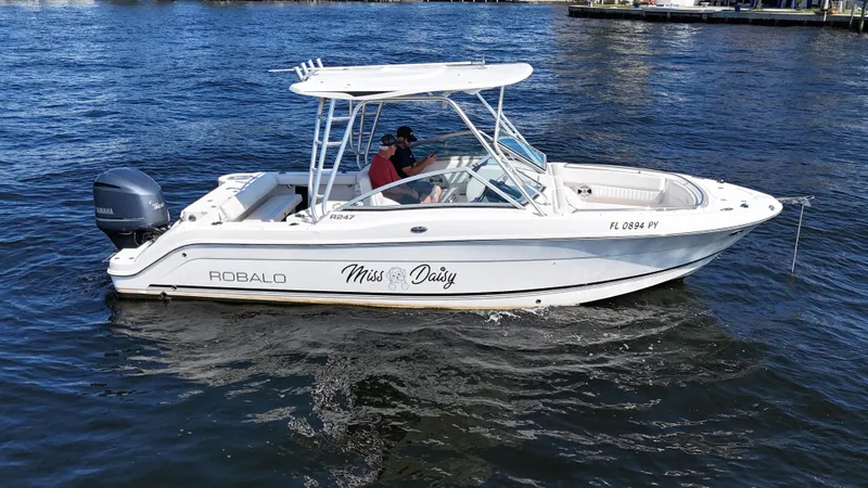 The Image of 2015 Robalo R247 Dual Console boat named "Miss Daisy" cruising on the water. - 0