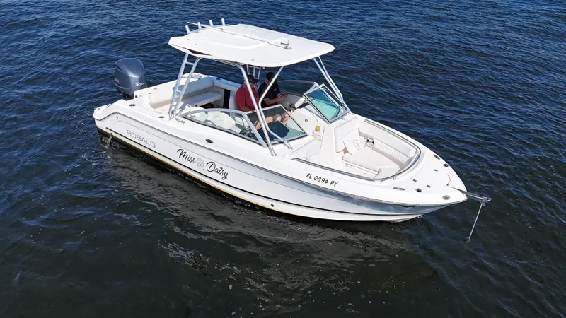 Slide: The Image of 2015 Robalo R247 Dual Console boat on open water. - 10