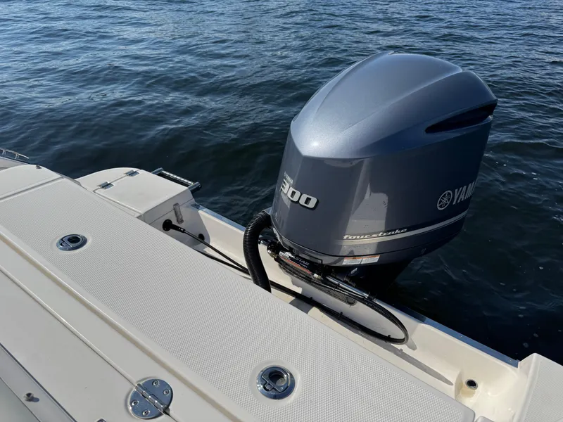 Slide: The Image of 2015 Robalo R247 Dual Console with Yamaha outboard engine on water. - 11