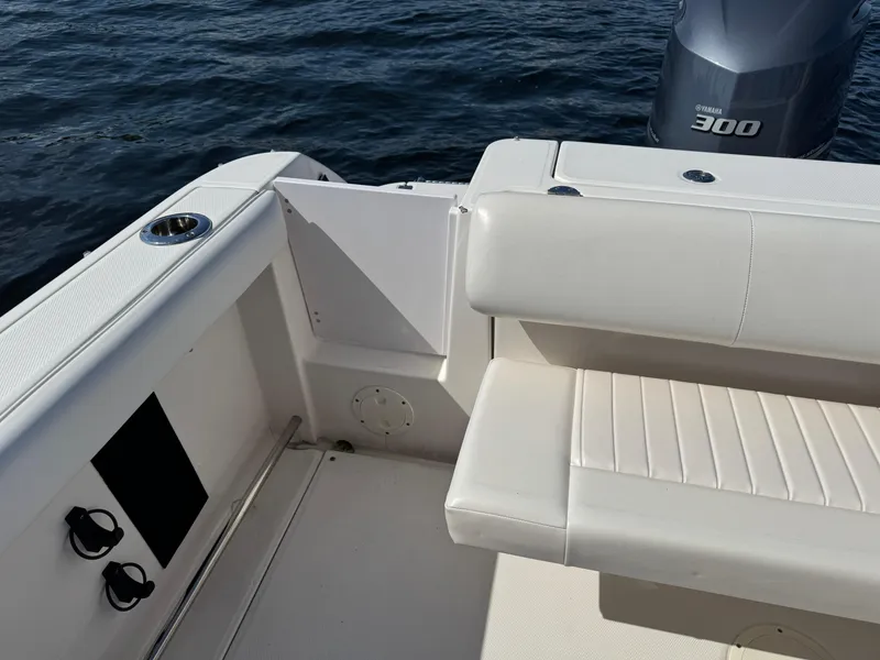 Slide: The Image of 2015 Robalo R247 Dual Console boat interior with seating and Yamaha 300 engine. - 12