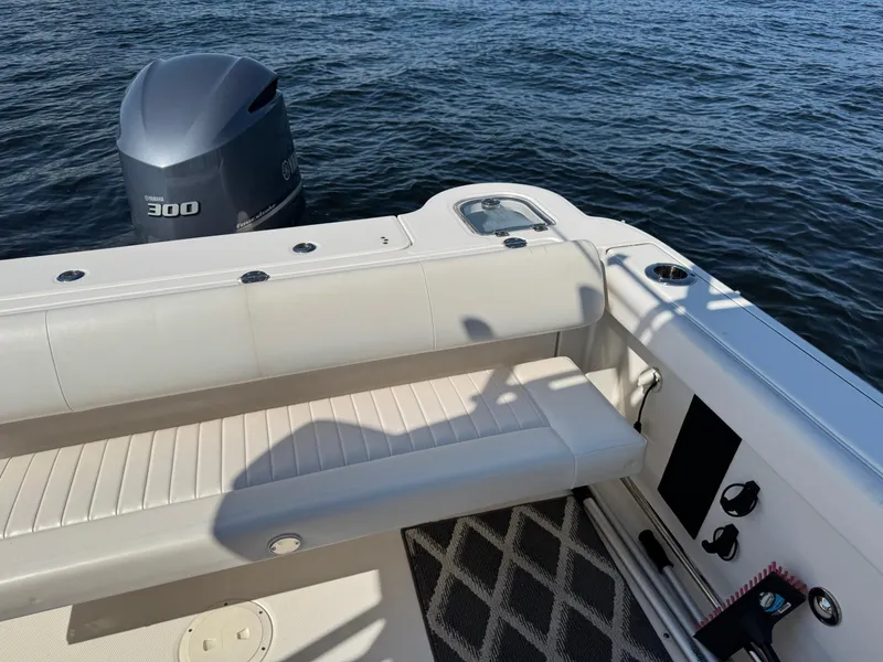 Slide: The Image of 2015 Robalo R247 Dual Console boat with Yamaha 300 engine on water. - 13
