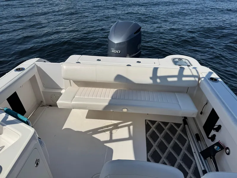 Slide: The Image of 2015 Robalo R247 Dual Console boat with seating and outboard motor on calm water. - 14