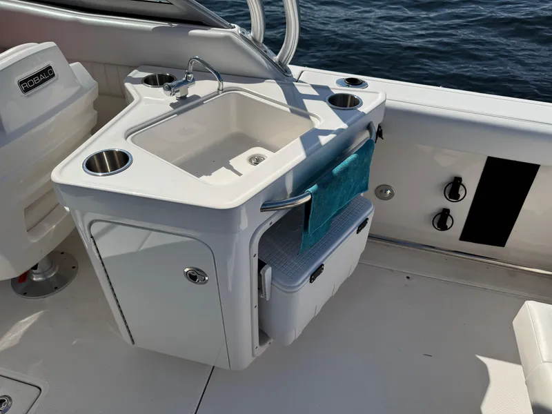Slide: The Image of 2015 Robalo R247 Dual Console boat with sink and storage on deck. - 15