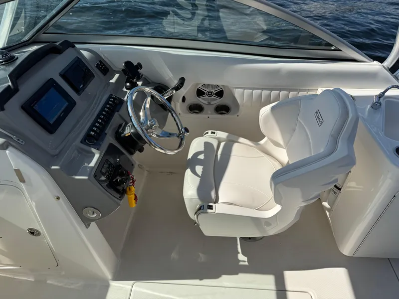 Slide: The Image of 2015 Robalo R247 Dual Console boat interior with steering wheel and captain's chair. - 21
