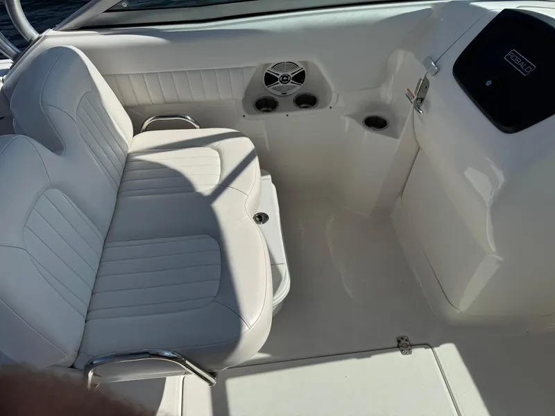 Slide: The Image of 2015 Robalo R247 Dual Console interior with white seating and console. - 23