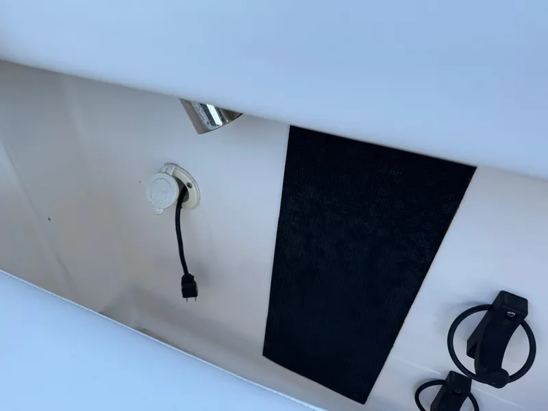 Slide: The Image of 2015 Robalo R247 Dual Console interior detail with plug and cup holders. - 25