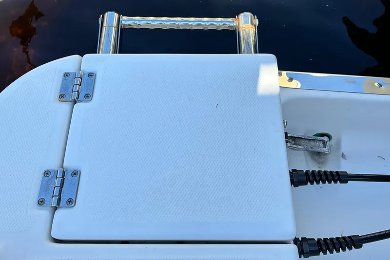 Slide: The Image of 2015 Robalo R247 Dual Console boat swim platform with ladder and hinges. - 26