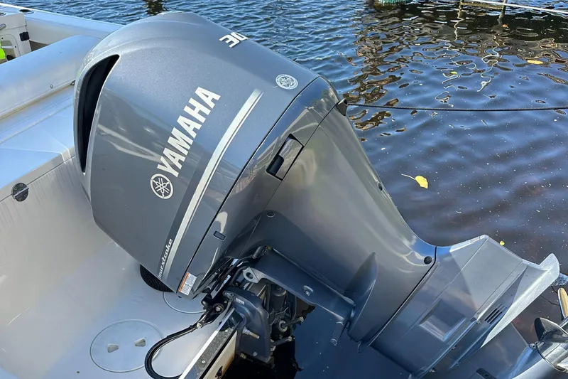 Slide: The Image of Yamaha outboard motor on 2015 Robalo R247 Dual Console boat, docked on water. - 27