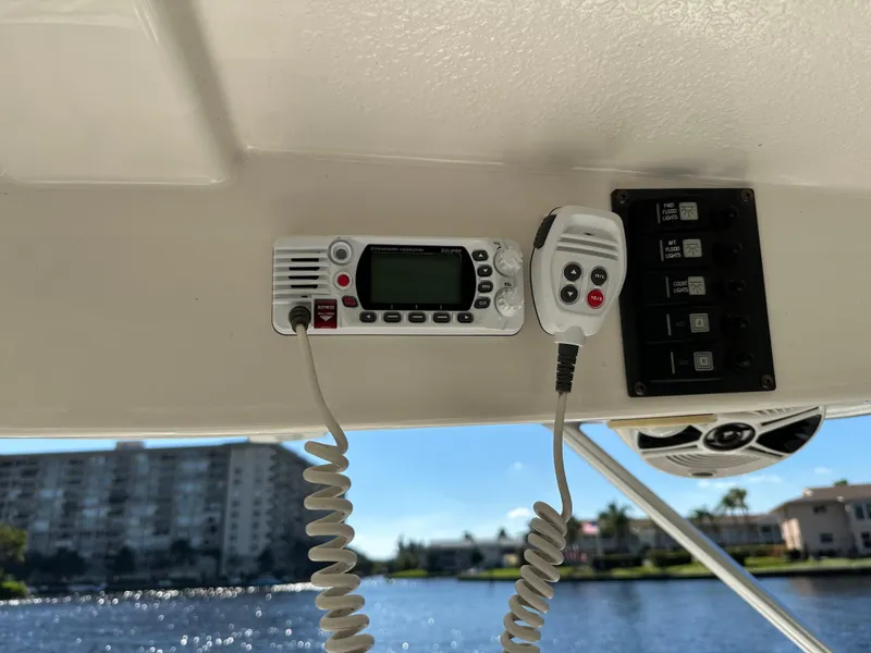 Slide: The Image of 2015 Robalo R247 Dual Console boat radio and control panel with waterfront view. - 28