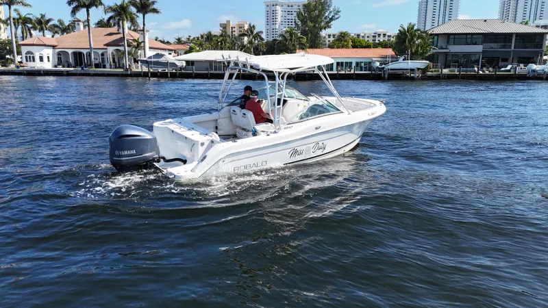 Slide: The Image of 2015 Robalo R247 Dual Console boat cruising on a sunny waterfront. - 3
