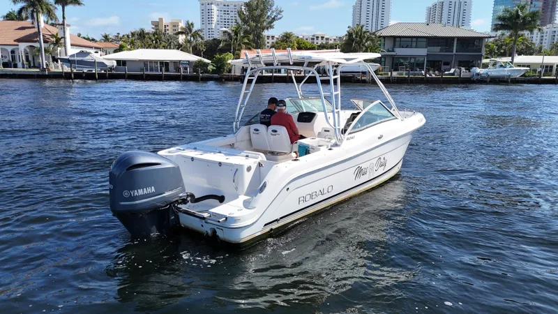 Slide: The Image of 2015 Robalo R247 Dual Console boat cruising on a sunny waterfront. - 4