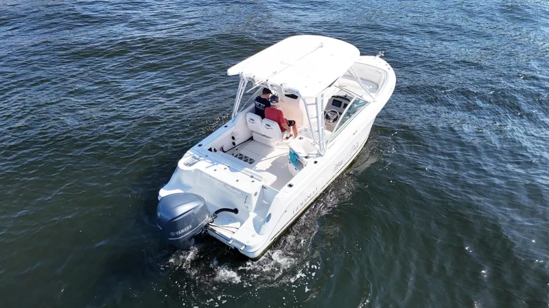 Slide: The Image of 2015 Robalo R247 Dual Console boat cruising on open water. - 7
