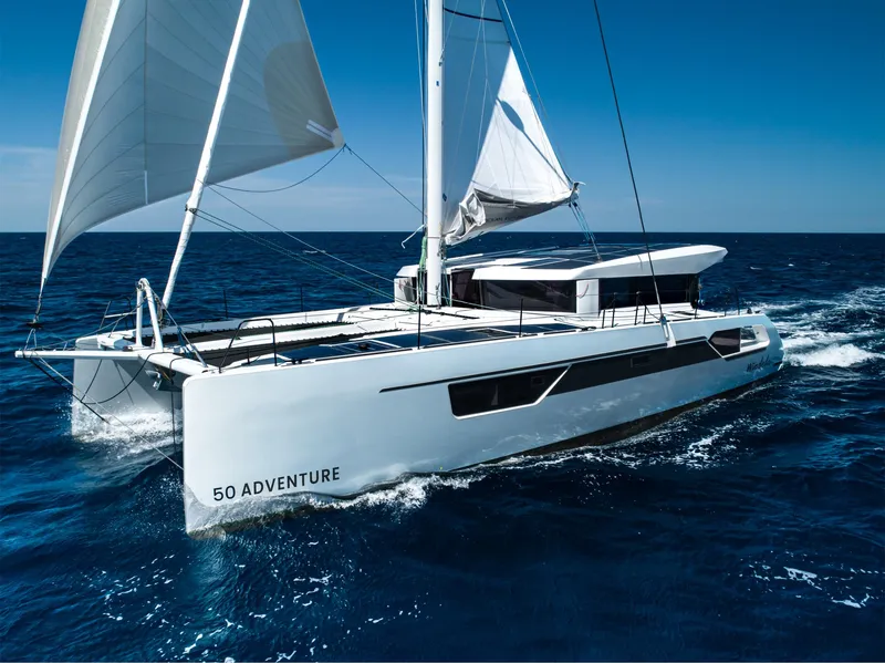 Slide: The Image of 2025 Windelo 50 Adventure catamaran sailing on open ocean. - 12