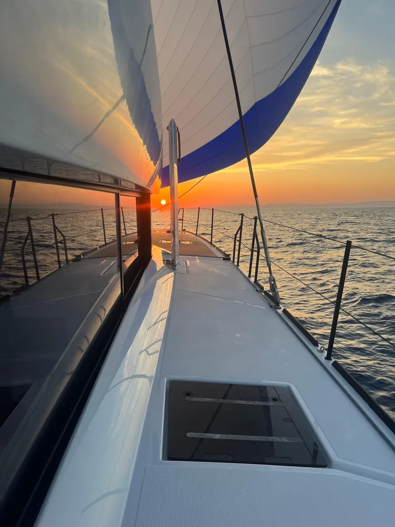 Slide: The Image of Windelo 50 Adventure 2025 yacht sailing at sunset on open sea. - 15