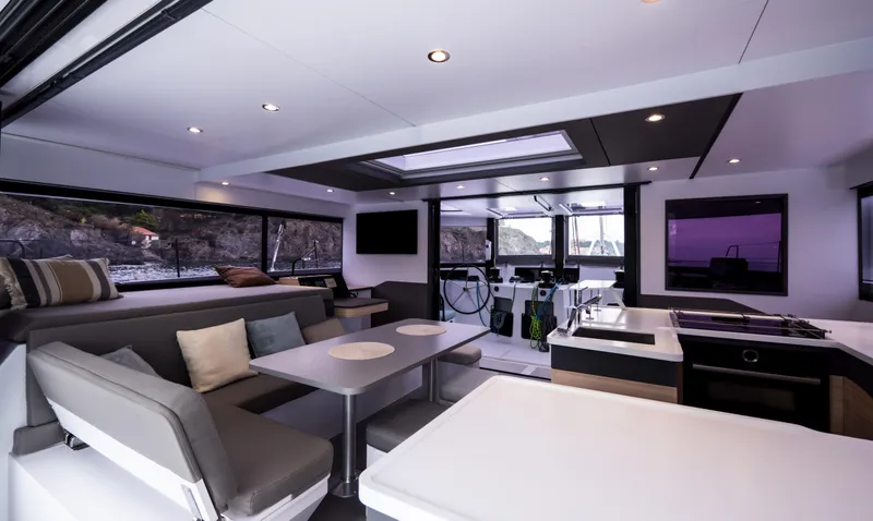 Slide: The Image of Interior of 2025 Windelo 50 Adventure yacht with modern seating and dining area. - 27