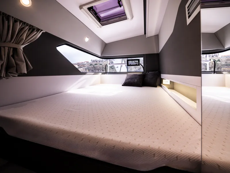 Slide: The Image of Luxurious bedroom in the 2025 Windelo 50 Adventure yacht with modern design and ample natural light. - 36
