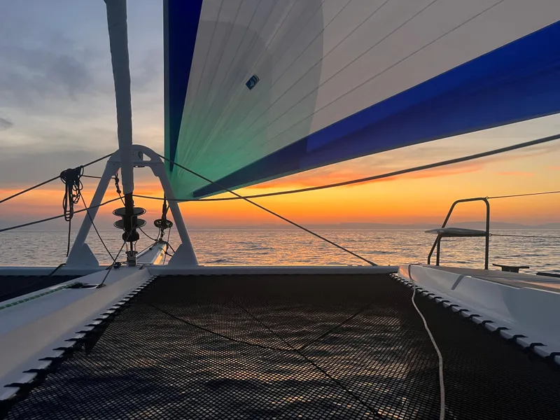 Slide: The Image of Windelo 50 Adventure 2025 catamaran sailing at sunset. - 16