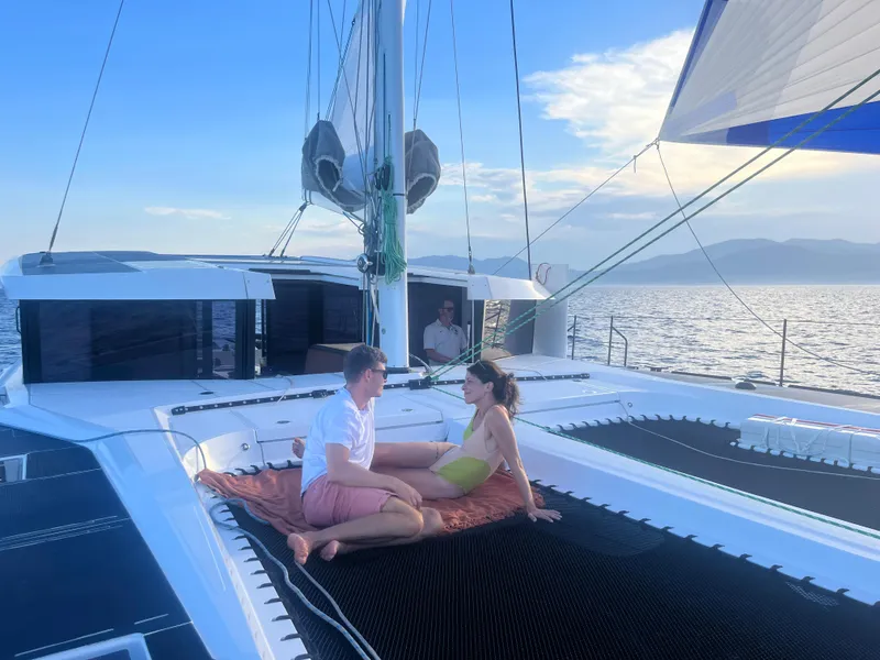 Slide: The Image of Couple relaxing on Windelo 50 Adventure catamaran, 2025 model, sailing at sunset. - 18