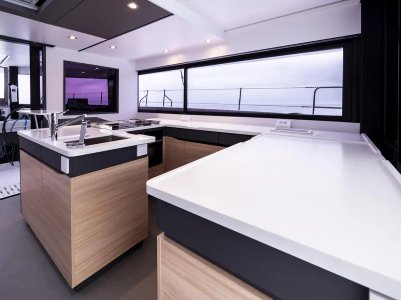 Slide: The Image of Modern kitchen interior of 2025 Windelo 50 Adventure yacht with sleek countertops and large windows. - 25