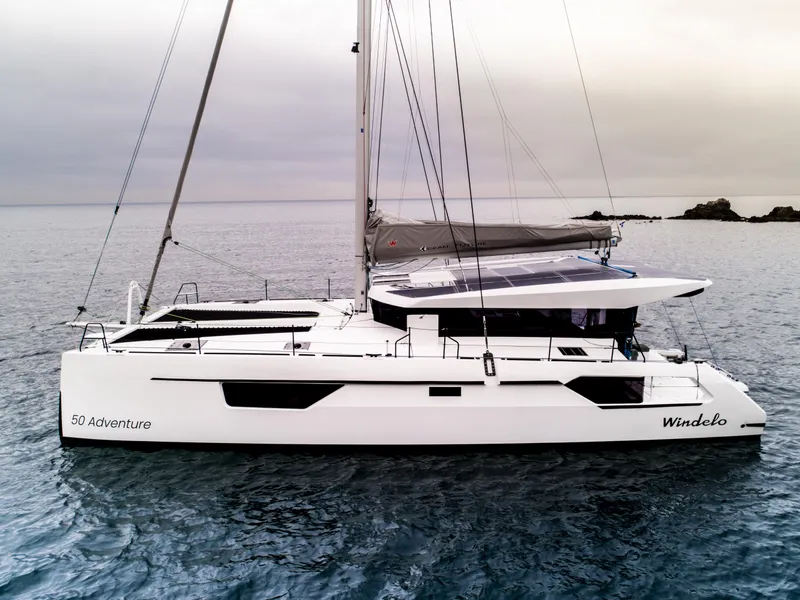 Slide: The Image of 2025 Windelo 50 Adventure catamaran sailing on calm waters. - 7