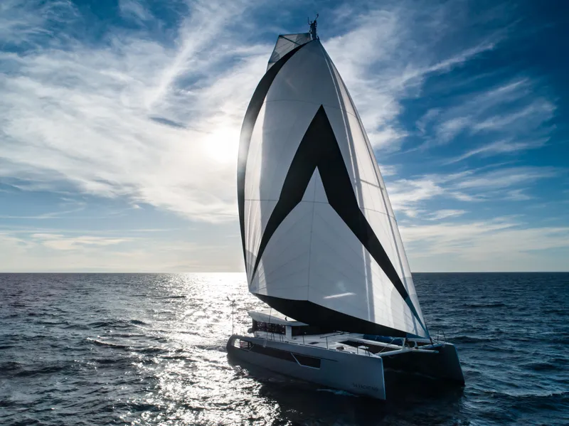 Slide: The Image of Windelo 54 sailing catamaran 2025 on open sea with dramatic sky. - 24